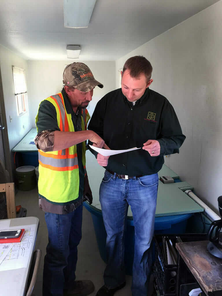 Materials Testing Consultants employees reviewing project blueprints