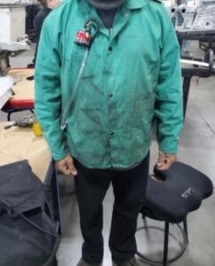 A worker wearing equipment to protect from air contaminants.
