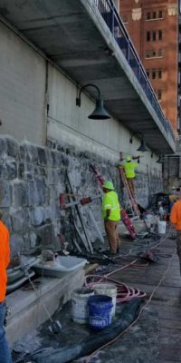 MTC employees verifying retaining wall construction in downtown Grand Rapids.
