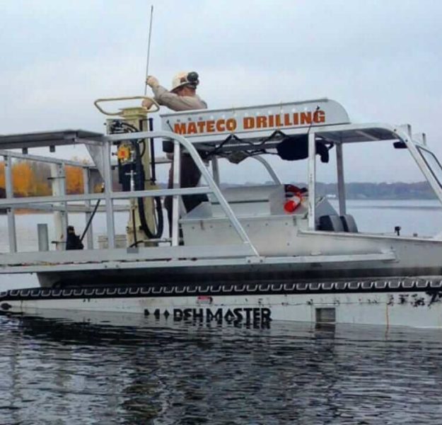 Employee performing sediment sampling on Marshmaster equipment for an environmental consulting project