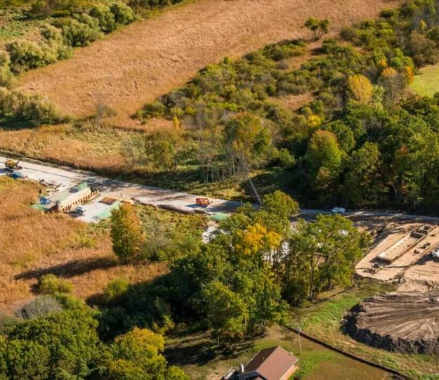 Aerial view of road project preparing to build a bridge for US-231 in Ottawa County, MI where MTC provided geotechnical sampling and soils testing of the ground