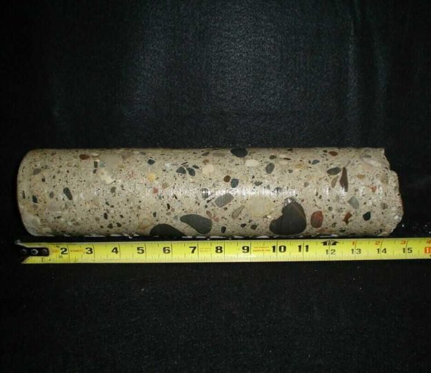14” by 4” diameter rock core sample showing different sediments/rock substances