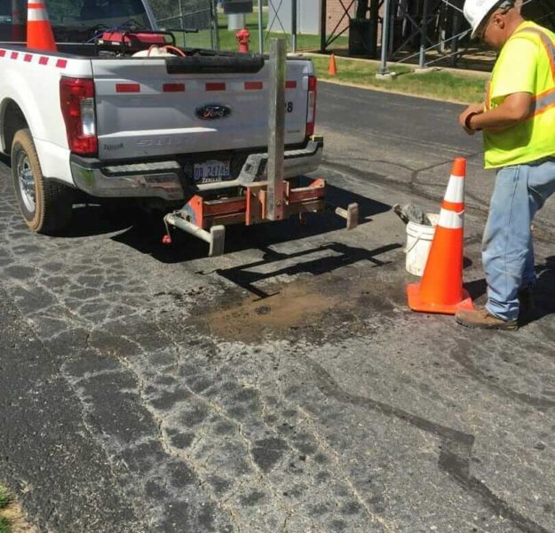 MTC asphalt engineering technician using a coring machine to obtain asphalt and subgrade samples