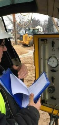 Geotechnical field staff using a Menard pressure meter to determine stress/strain response of the soil on a project