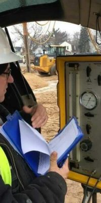 Geotechnical field staff using a Menard pressure meter to determine stress/strain response of the soil on a project